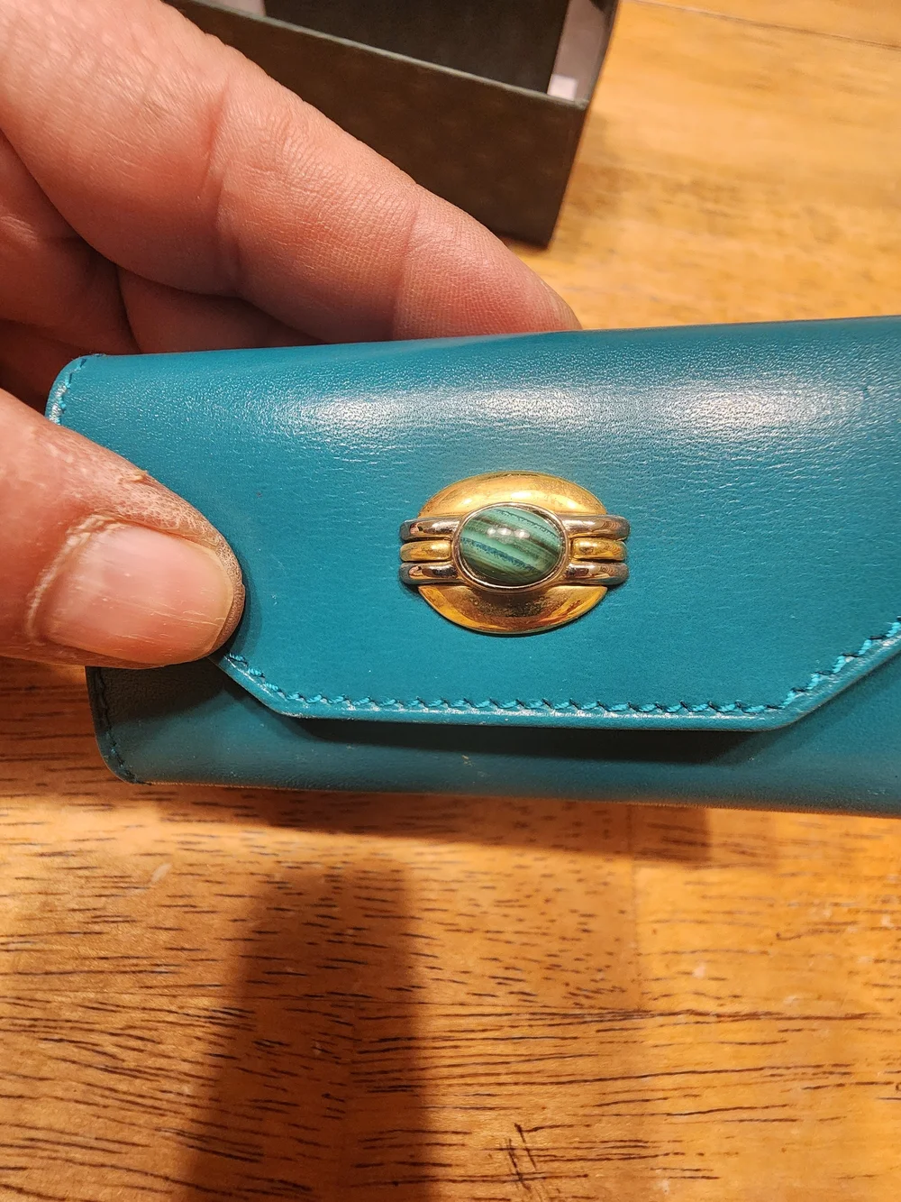 vintage Gucci teal leather key case featuring a distinctive cabochon stone